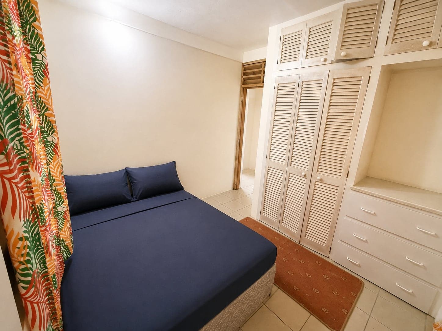 The second bedroom, with fitted wardrobes and storage