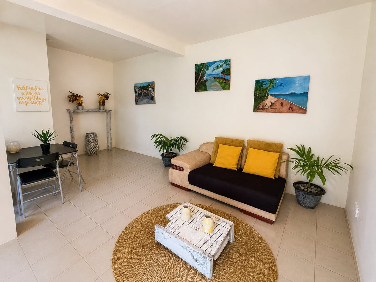 The living room of the apartment, with local paintings on the walls